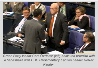Green Party leader Cem Özdemir (left) seals the promise with a handshake with CDU Parliamentary Faction Leader Volker Kauder