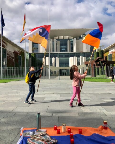 Children wave the flags of Artsakh and Armenia